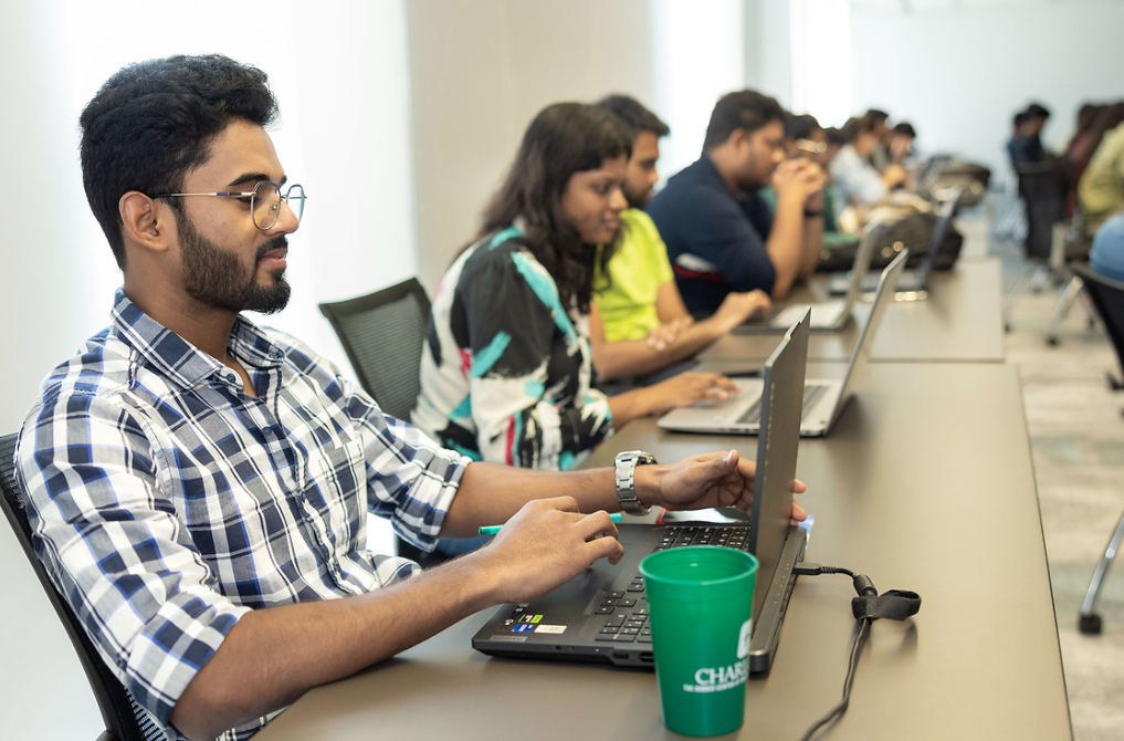 Students in a classroom on their laptops.
